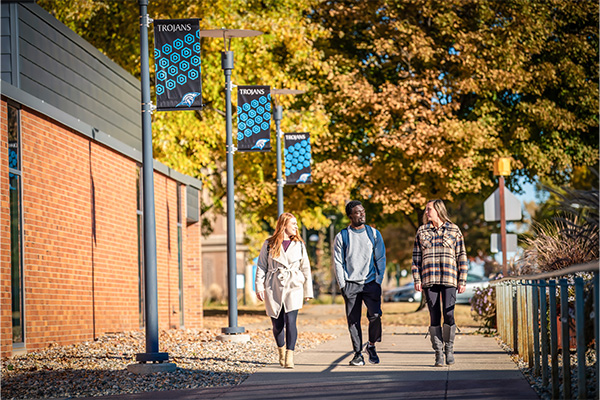 Students walking on DSU's campus in fall.